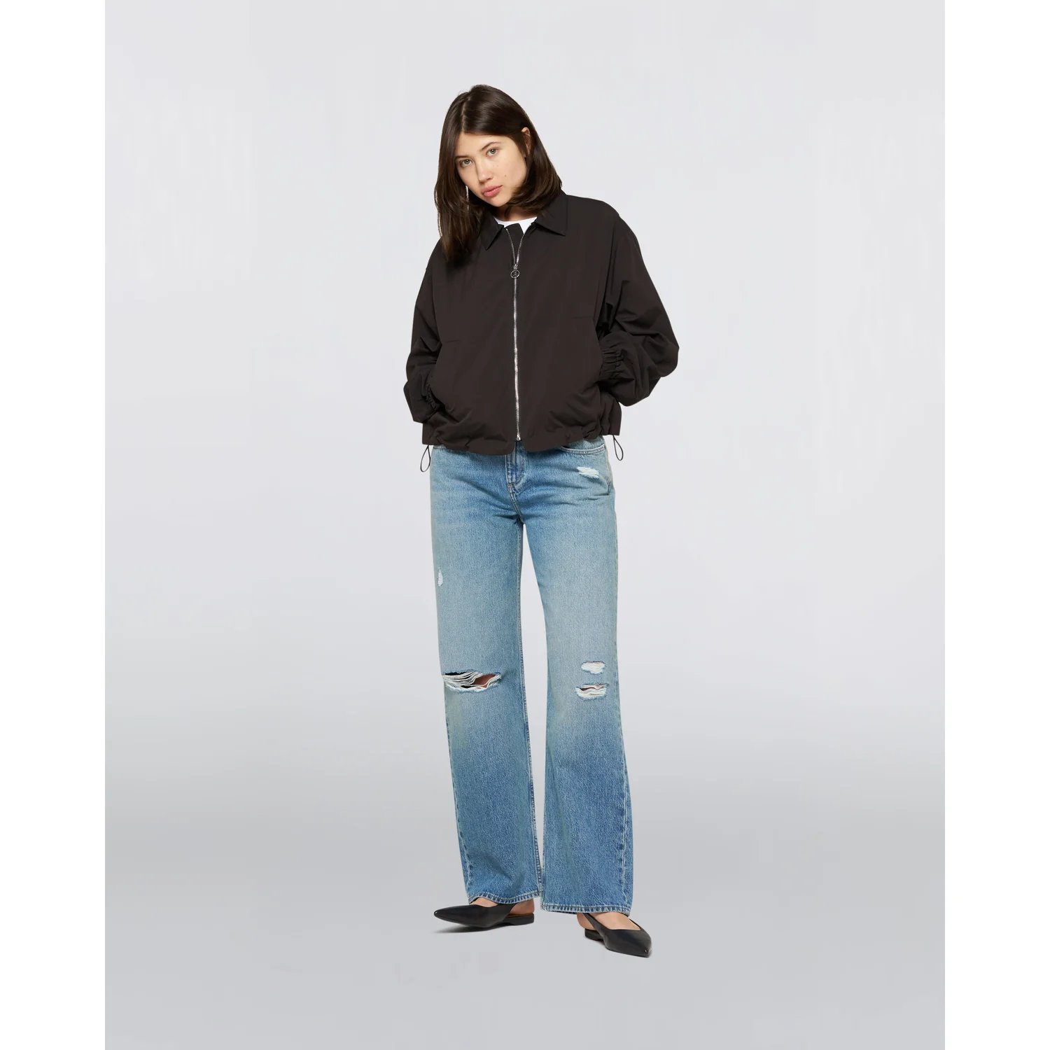 schwarze Jacke, Reißverschluss, blaue Jeans, weite Passform, Destroyed-Details