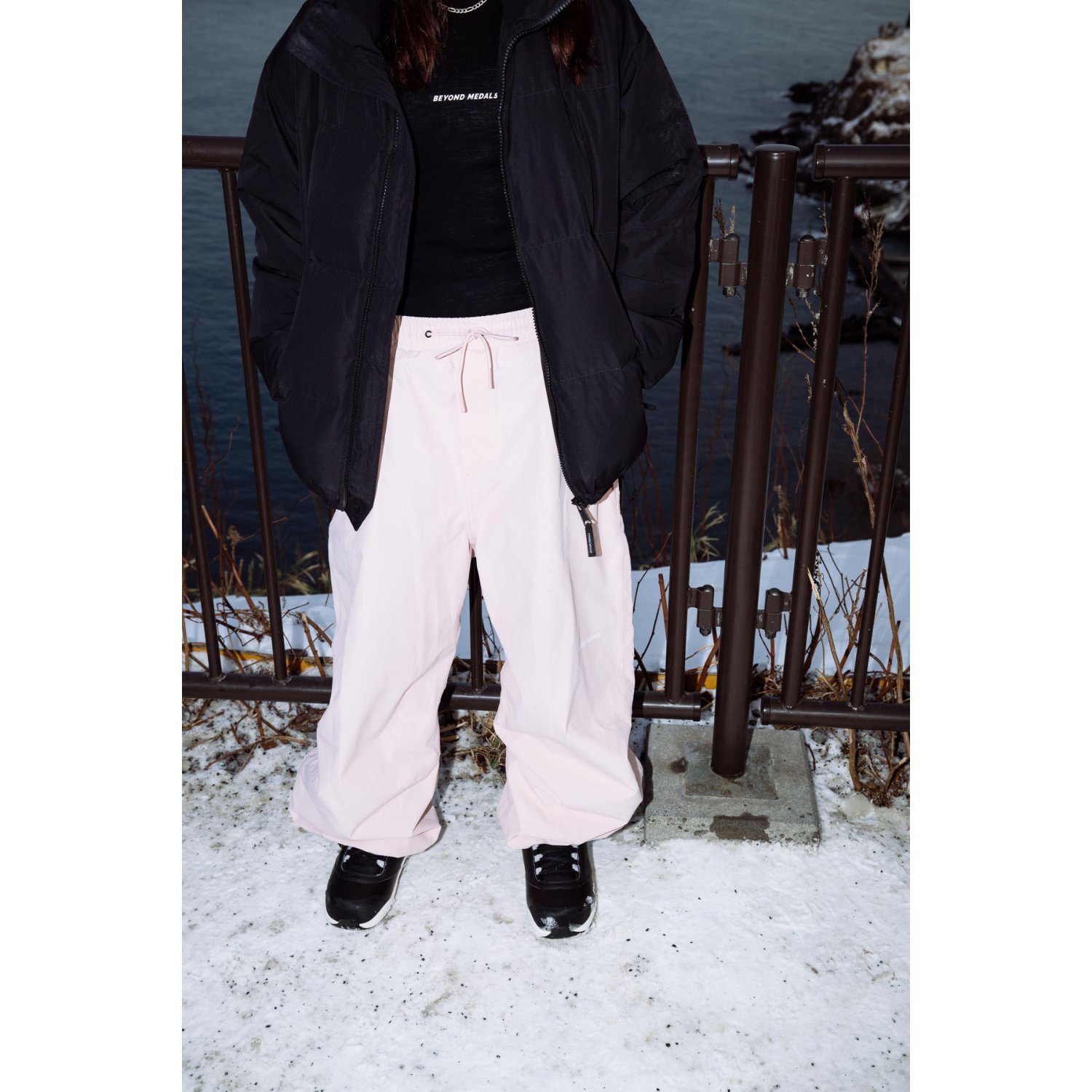 winter pants, pink trousers, drawstring waistband, black jacket, slip-on shoes