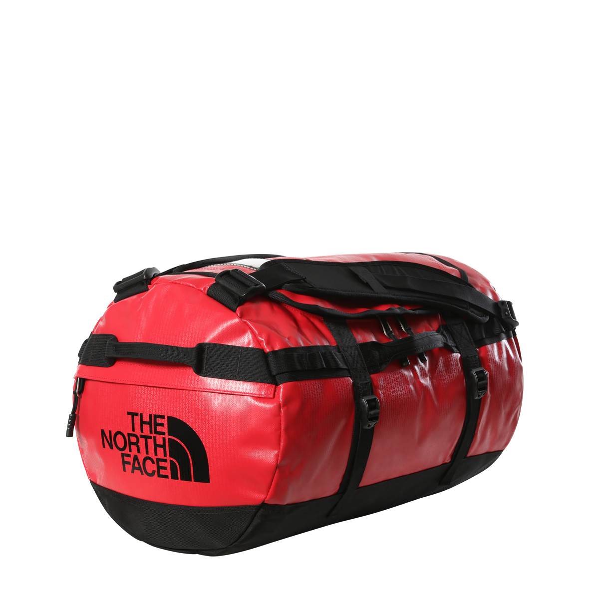 Rote Base Camp Duffel S Rote The North Face Base Camp Duffel-Tasche S auf weißem Grund. Robustes, glänzendes, wasserabweisendes Material mit schwarzem Boden. Schwarze Kompressionsriemen, gepolsterte Schultergurte. Logo seitlich sichtbar.