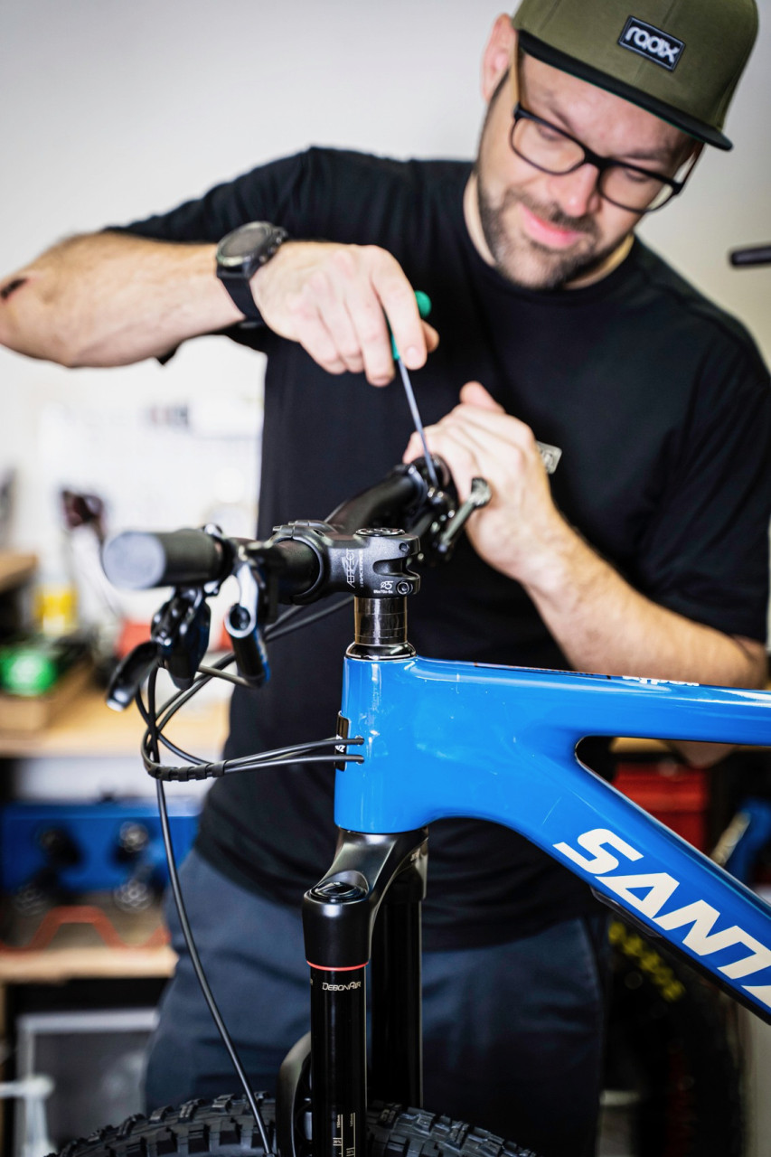 Un mécanicien règle les freins sur le guidon d'un nouveau vélo Santa Cruz Bikes